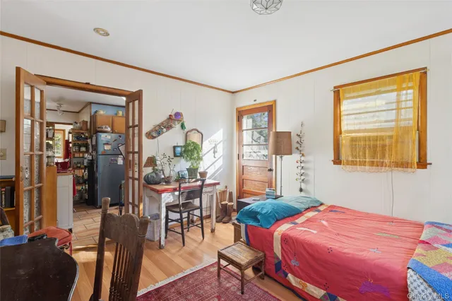 a bedroom with a bed and wooden floor