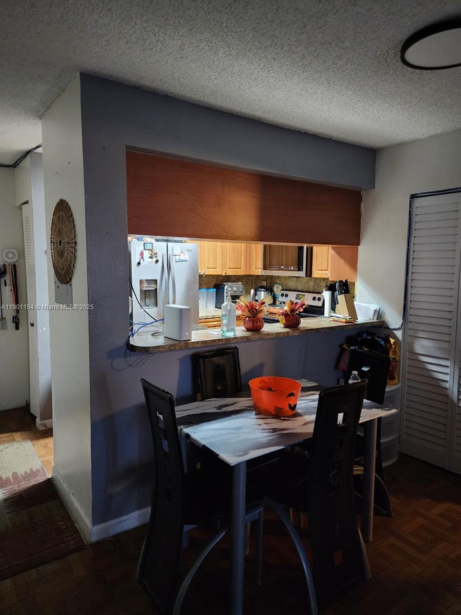 2221 Sherman Circle South, Unit 304 Miramar, FL 33025 - Photo 2 of 10 a outdoor dining space with a table and chairs