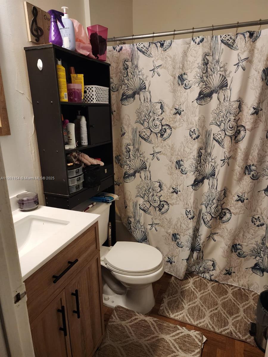 2221 Sherman Circle South, Unit 304 Miramar, FL 33025 - Photo 4 of 10 a bathroom with a sink and a toilet