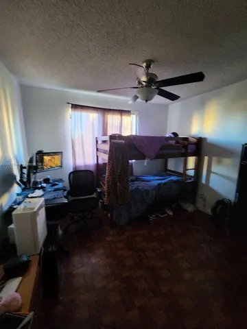 a view of a livingroom with furniture and a window