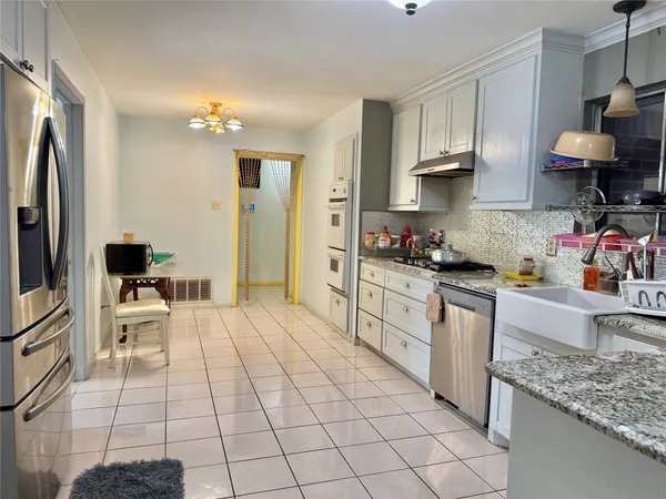 a kitchen with stainless steel appliances granite countertop a sink and a stove
