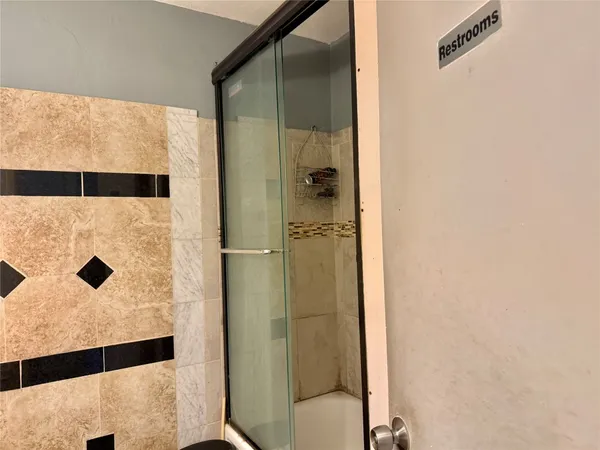 a bathroom with a shower and a mirror