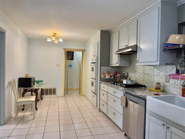a kitchen with a sink cabinets and appliances