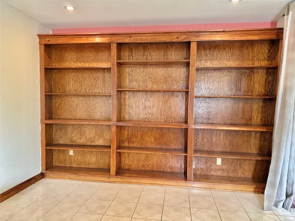 a view of an empty room with empty shelves