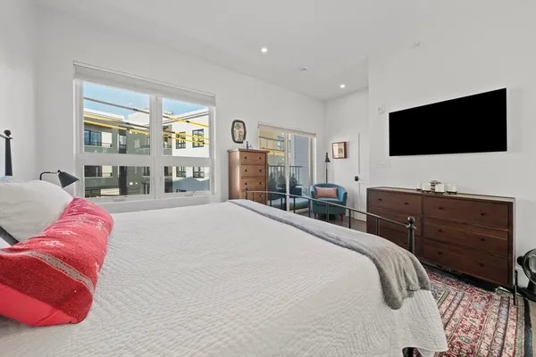 a bedroom with a bed and a flat screen television