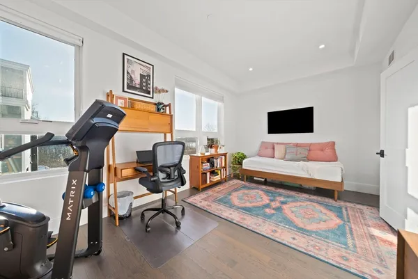 a bedroom with furniture and a flat screen tv