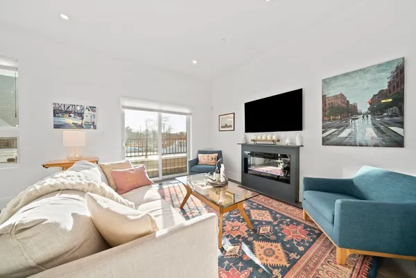 a living room with furniture a fireplace and a flat screen tv