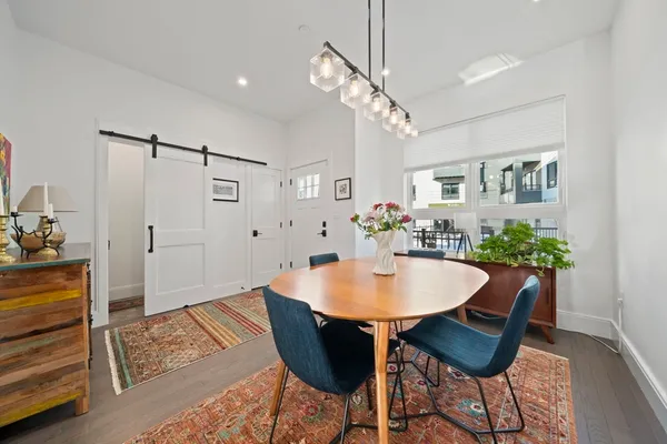 a view of a dining room with furniture and wooden floor