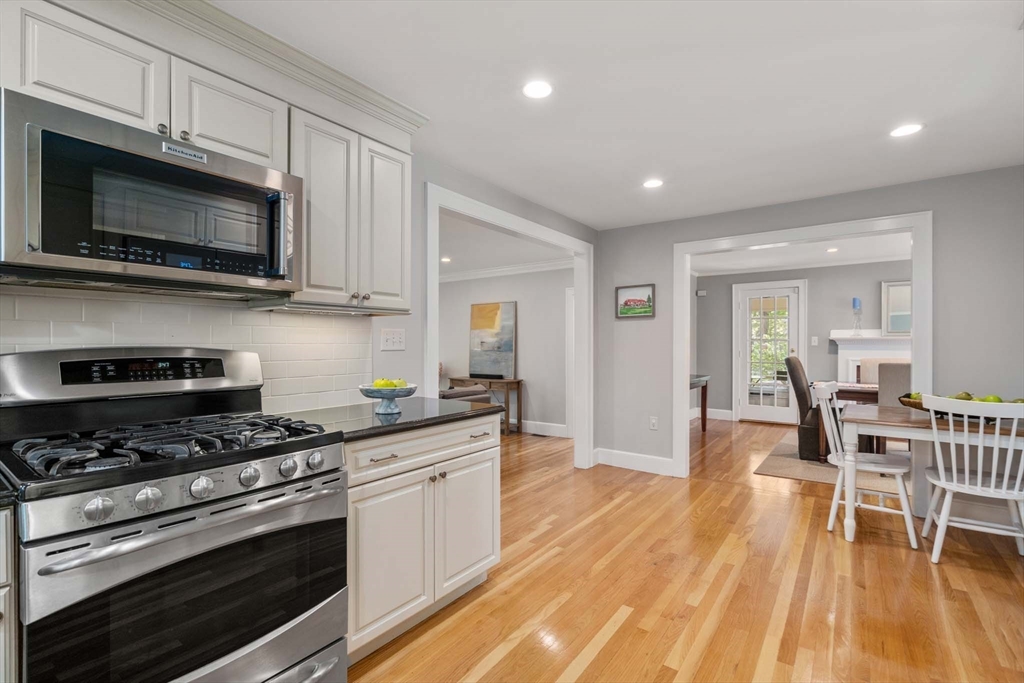 92 Parker Road Wellesley, MA 02482 - Photo 13 of 39 a kitchen with stainless steel appliances kitchen island granite countertop a stove a microwave a sink and cabinets