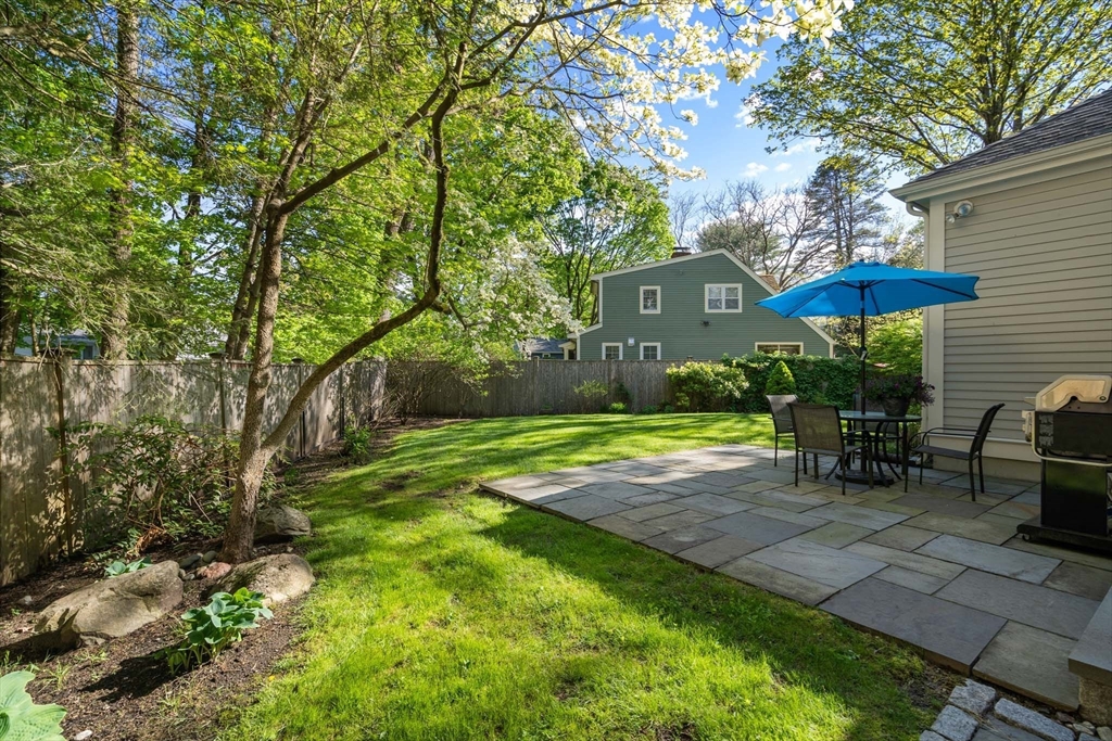 92 Parker Road Wellesley, MA 02482 - Photo 34 of 39 a view of a patio with table and chairs under an umbrella
