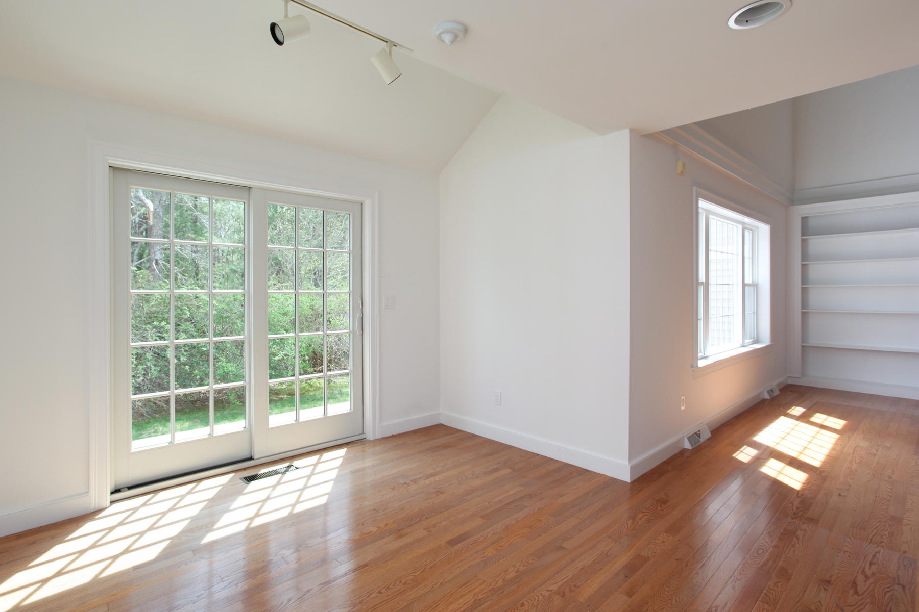 15 Hampton Court, Unit 15 Mashpee, MA 02649 - Photo 13 of 33 a view of empty room with wooden floor and fan