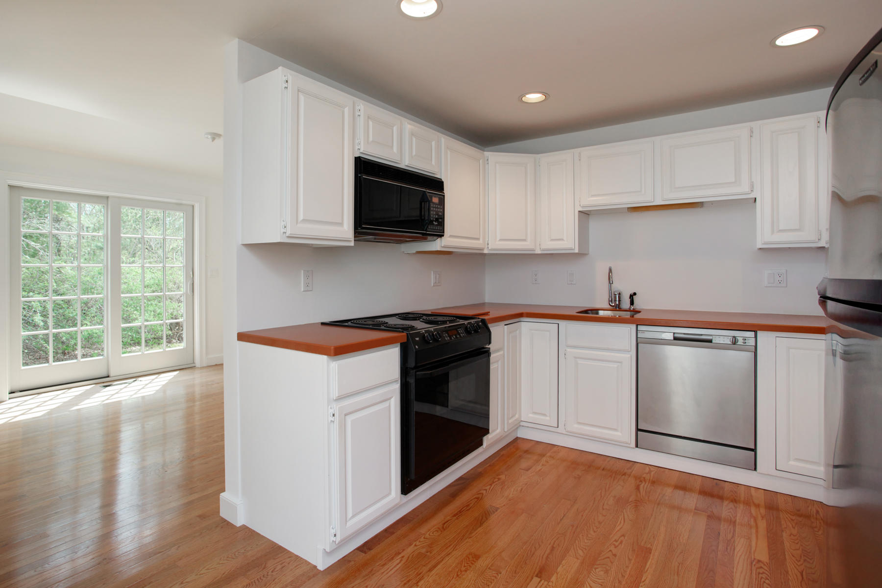 15 Hampton Court, Unit 15 Mashpee, MA 02649 - Photo 14 of 33 a kitchen with stainless steel appliances granite countertop a stove a sink and a microwave