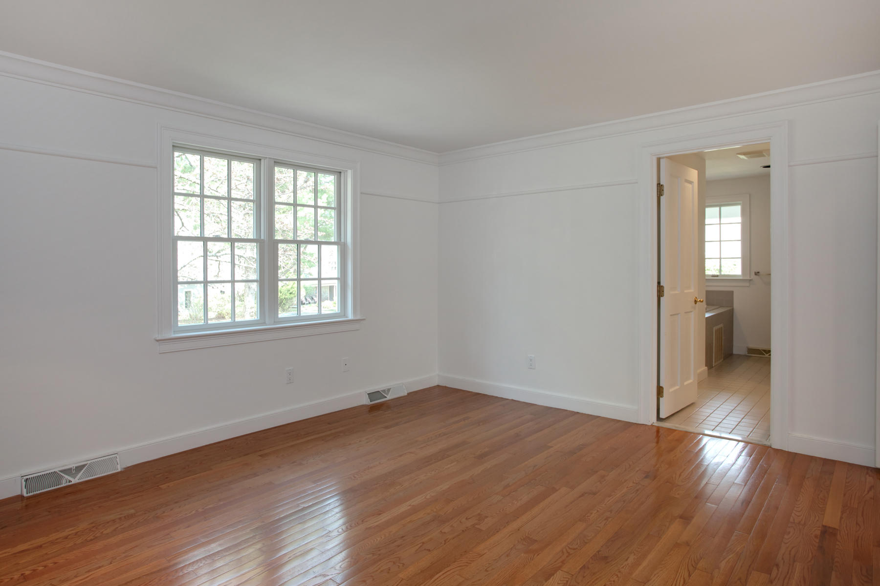 15 Hampton Court, Unit 15 Mashpee, MA 02649 - Photo 17 of 33 wooden floor in an empty room with a window