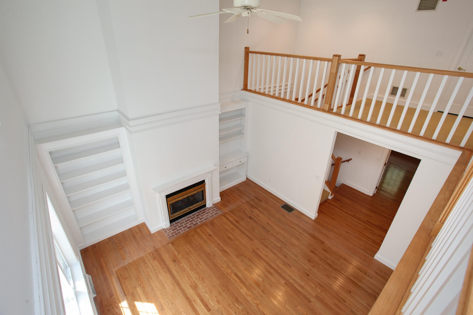 15 Hampton Court, Unit 15 Mashpee, MA 02649 - Photo 21 of 33 a view of an empty room with wooden floor and staircase