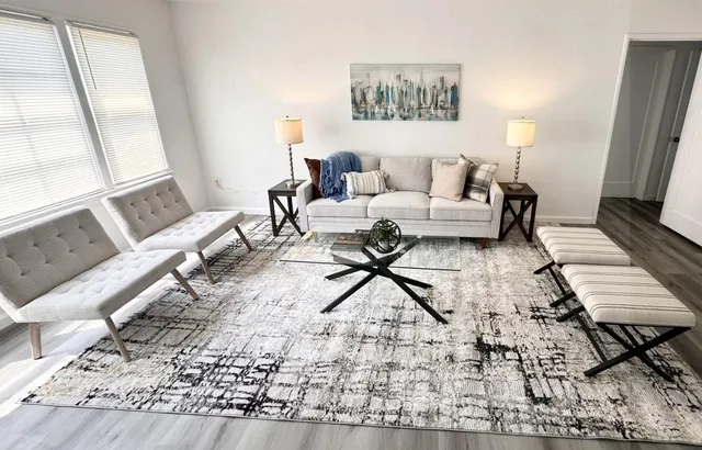 a living room with furniture and a rug