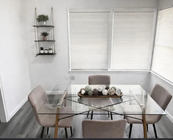 a dining room with furniture and window