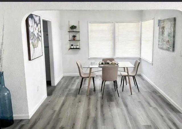 a view of a dining room with furniture and wooden floor