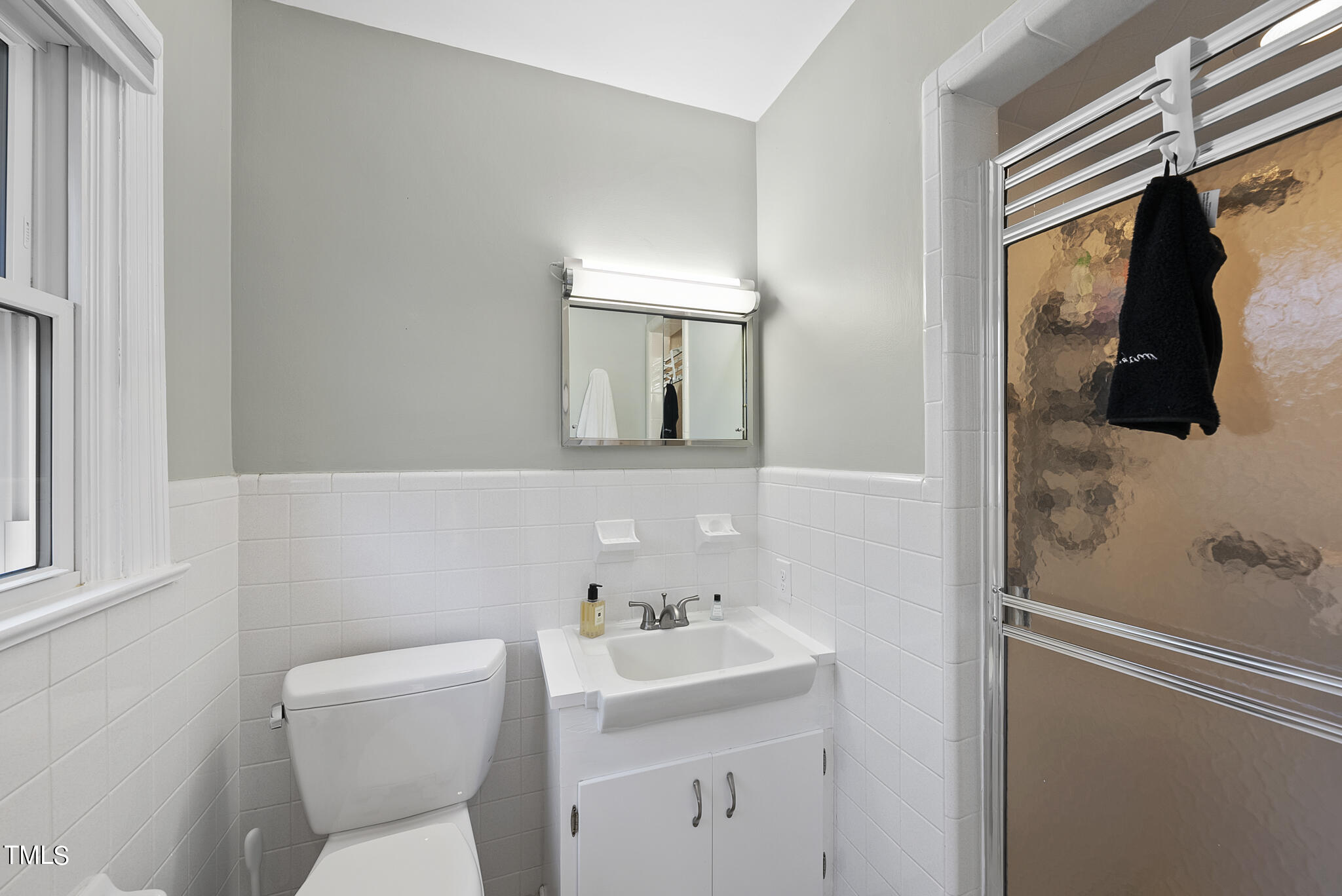 410 Goodwin Road Durham, NC 27712 - Photo 19 of 31 a bathroom with a toilet sink and mirror