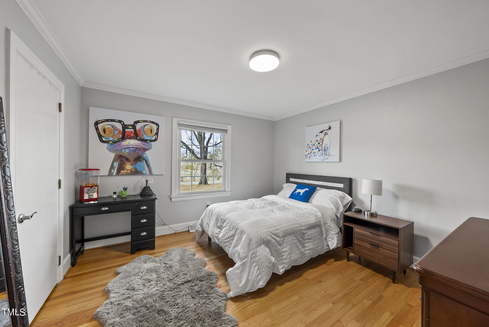 410 Goodwin Road Durham, NC 27712 - Photo 20 of 31 a bedroom with a bed and a chandelier