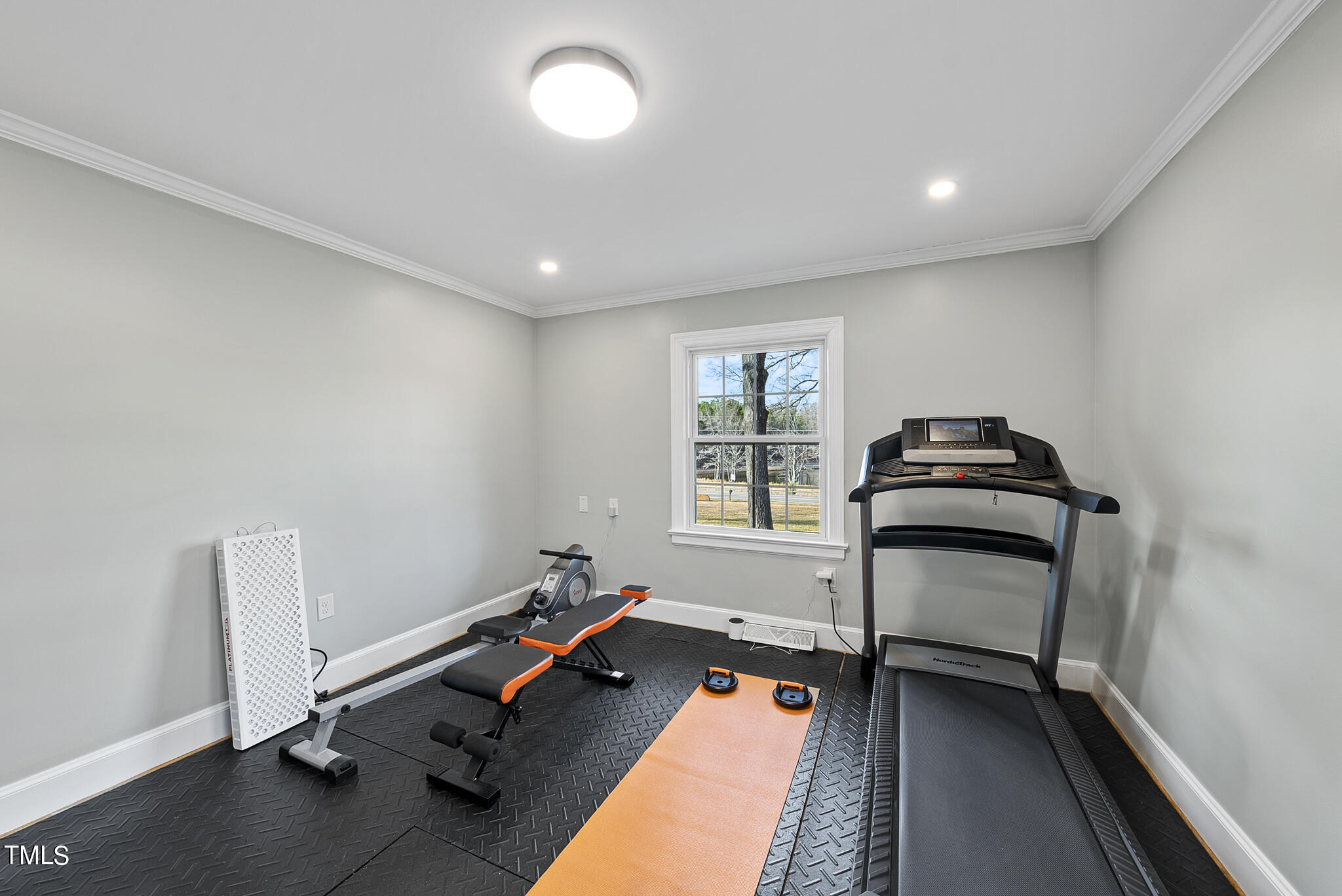 410 Goodwin Road Durham, NC 27712 - Photo 24 of 31 a room with gym equipment and a window