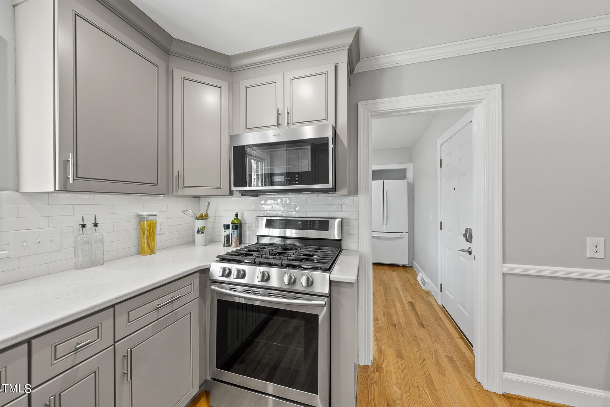 410 Goodwin Road Durham, NC 27712 - Photo 10 of 31 a kitchen with granite countertop a stove a sink and a microwave