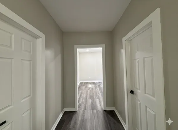 a view of a hallway with wooden floor and closet area