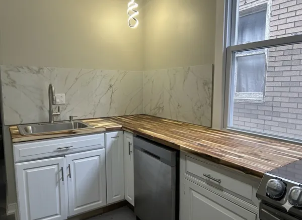 a kitchen with a sink and cabinets