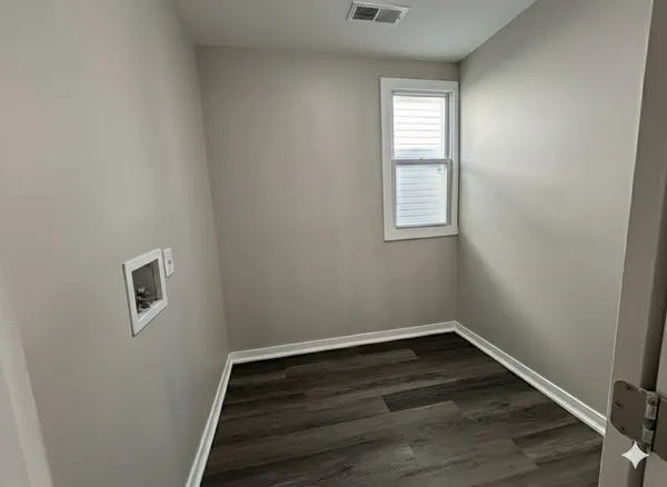 a bathroom with a toilet sink vanity and mirror