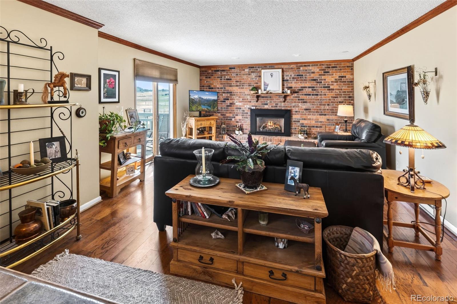 12360 South Mesa View Road Larkspur, CO 80118 - Photo 14 of 50 a living room with furniture and a flat screen tv