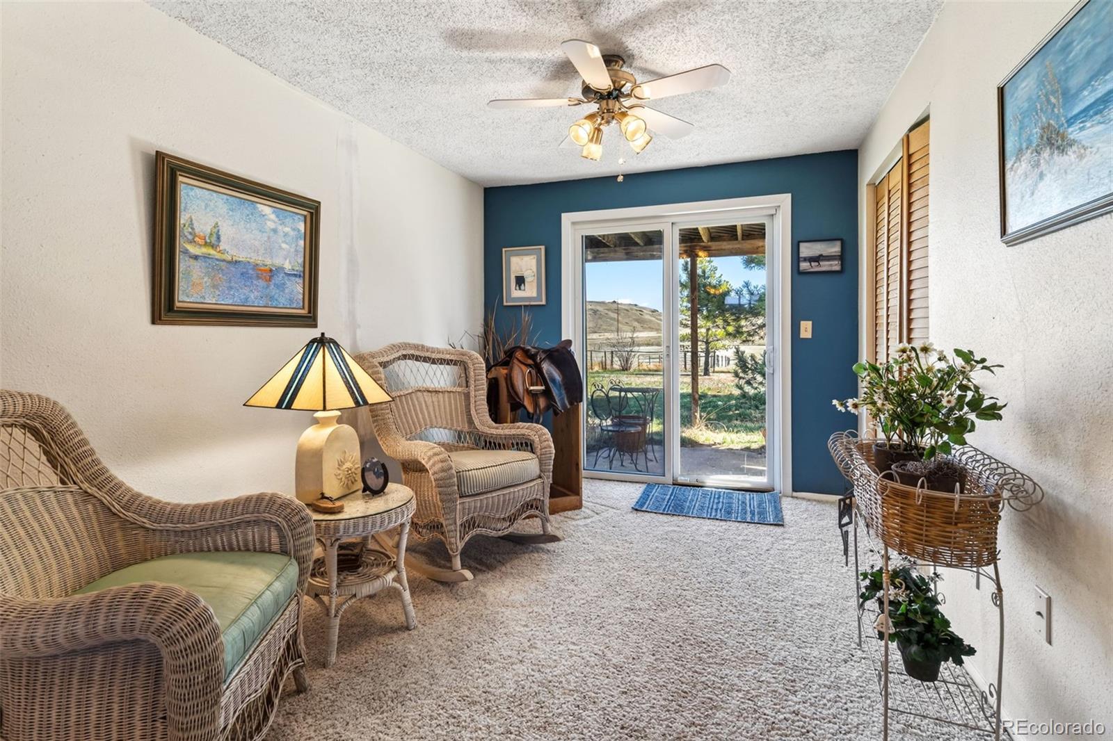 12360 South Mesa View Road Larkspur, CO 80118 - Photo 16 of 50 a living room with furniture and a large window