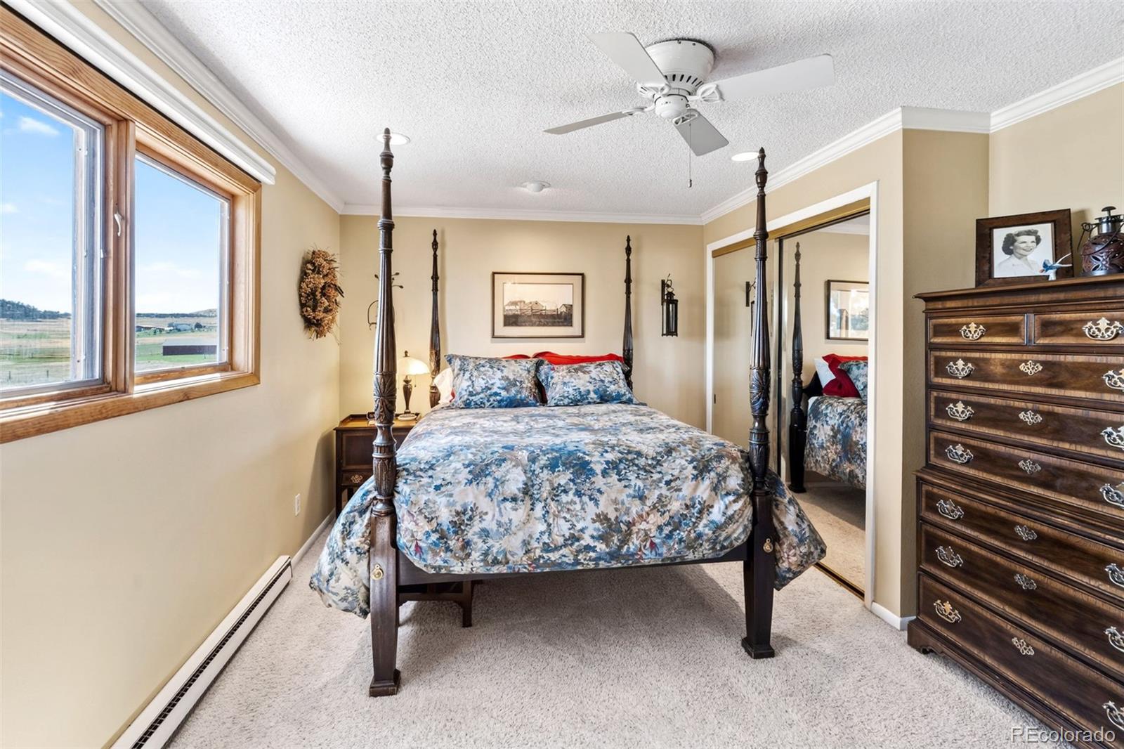 12360 South Mesa View Road Larkspur, CO 80118 - Photo 20 of 50 a bedroom with a bed and a dresser