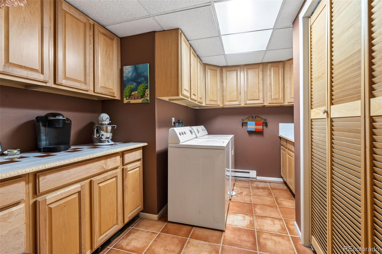 12360 South Mesa View Road Larkspur, CO 80118 - Photo 24 of 50 a utility room with cabinets washer and dryer