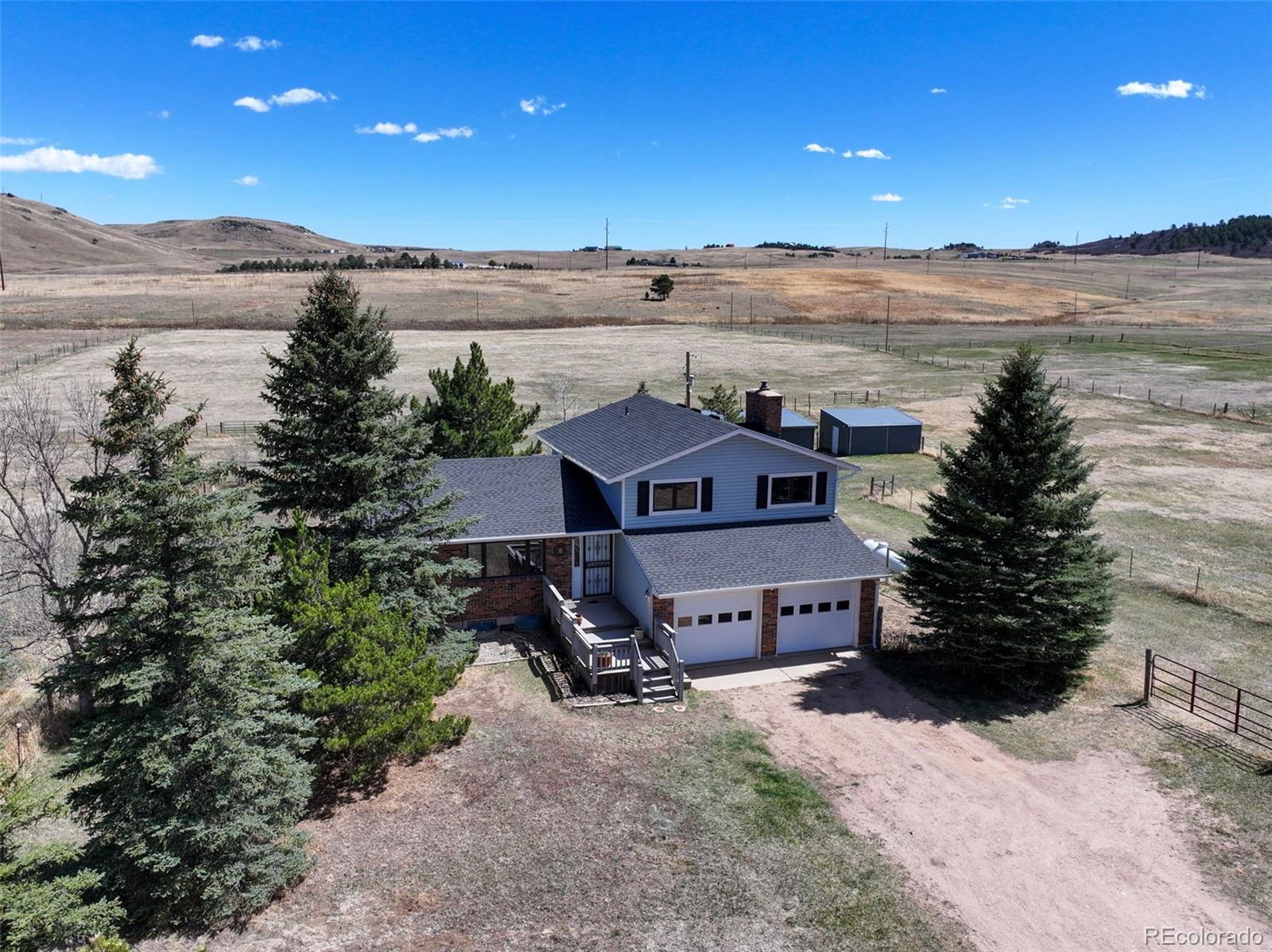 12360 South Mesa View Road Larkspur, CO 80118 - Photo 28 of 50 a view of a terrace with a garden and mountain view