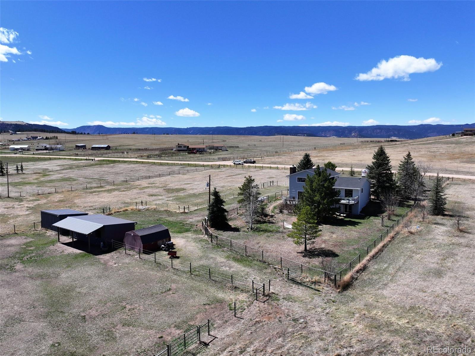 12360 South Mesa View Road Larkspur, CO 80118 - Photo 29 of 50 a view of a lake with a beach
