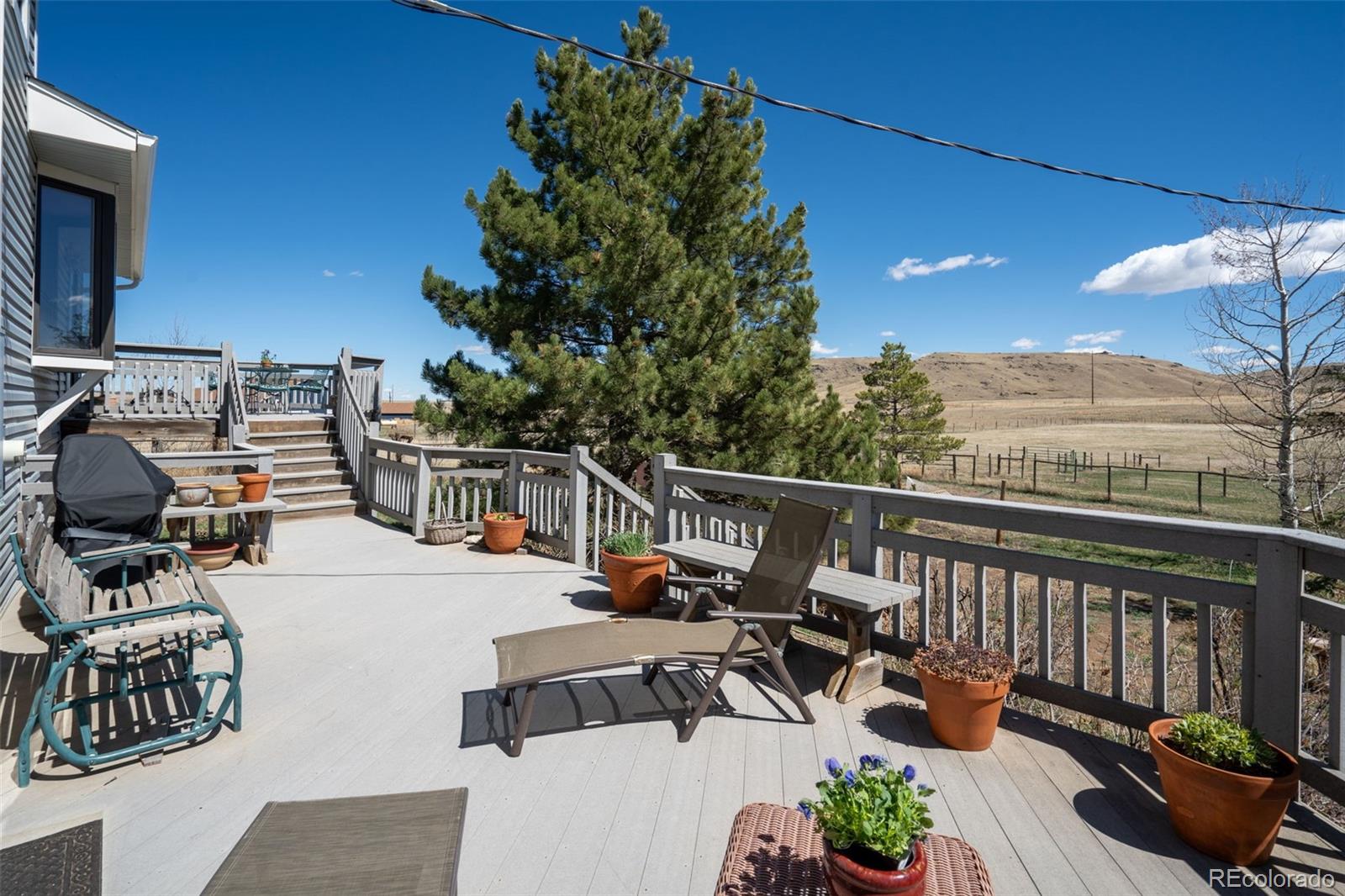 12360 South Mesa View Road Larkspur, CO 80118 - Photo 34 of 50 a view of a balcony with chairs
