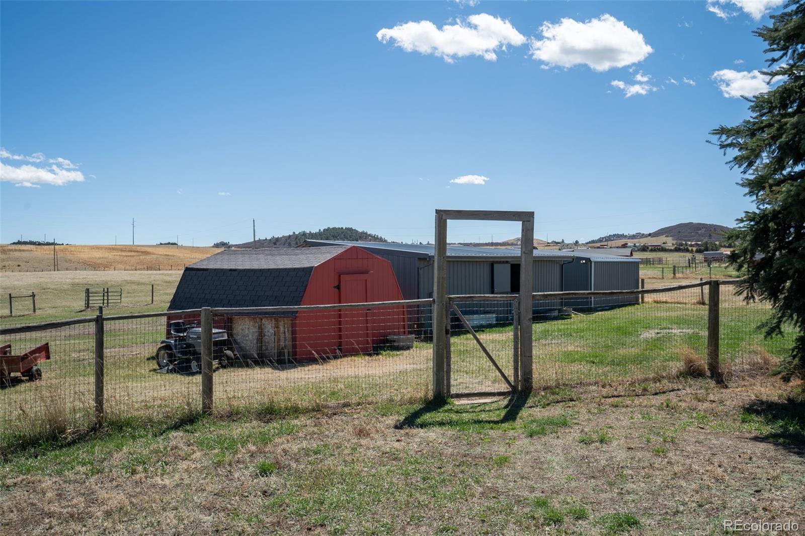 12360 South Mesa View Road Larkspur, CO 80118 - Photo 36 of 50 a view of a house with a backyard