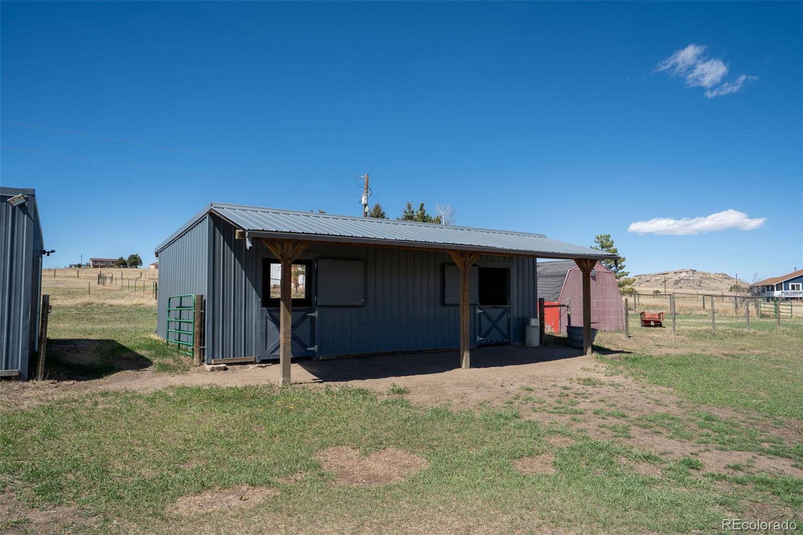 12360 South Mesa View Road Larkspur, CO 80118 - Photo 39 of 50 a view of a house with a yard and a garage