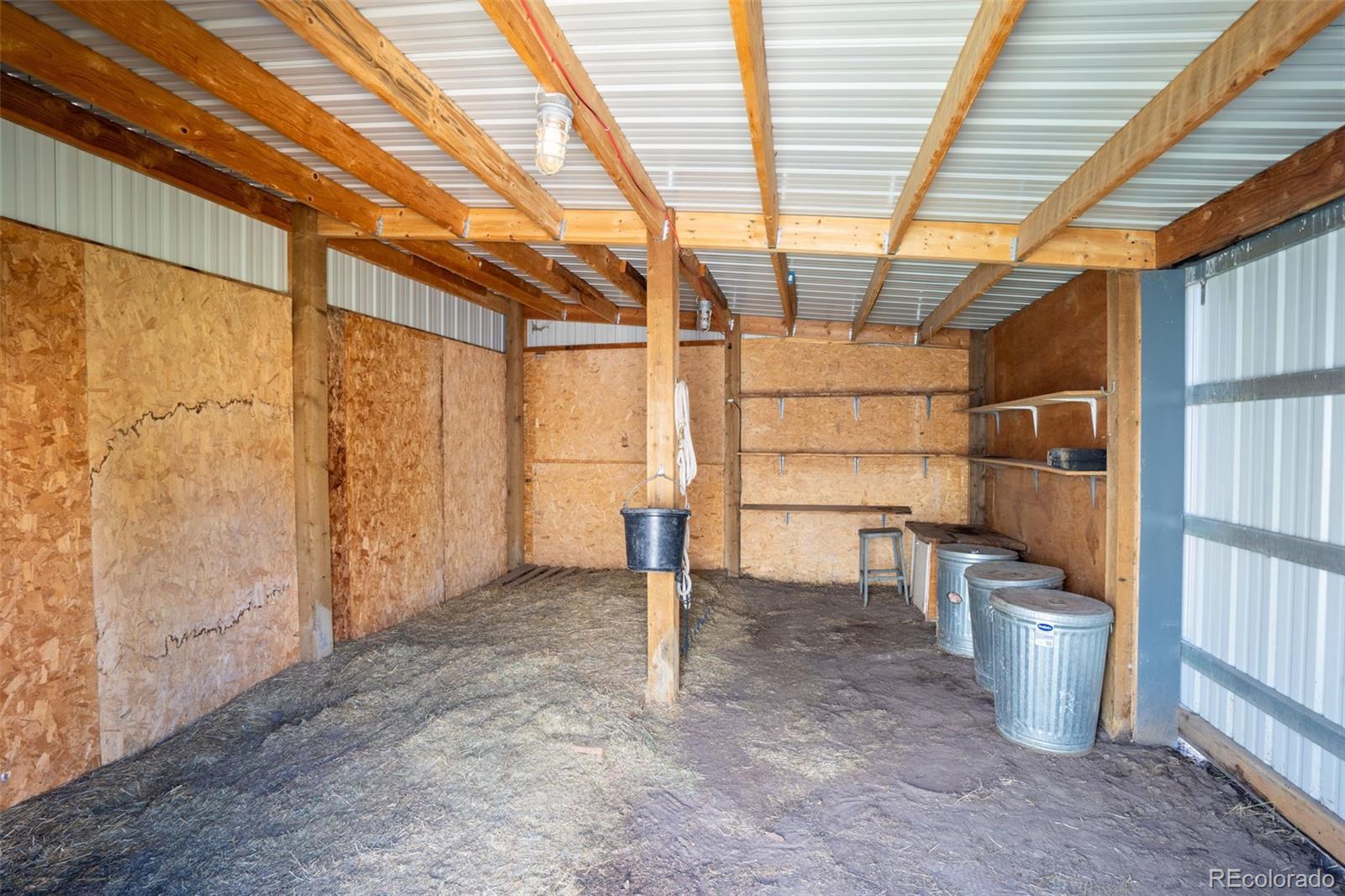 12360 South Mesa View Road Larkspur, CO 80118 - Photo 42 of 50 a view of an empty room with a empty space and wooden shelves