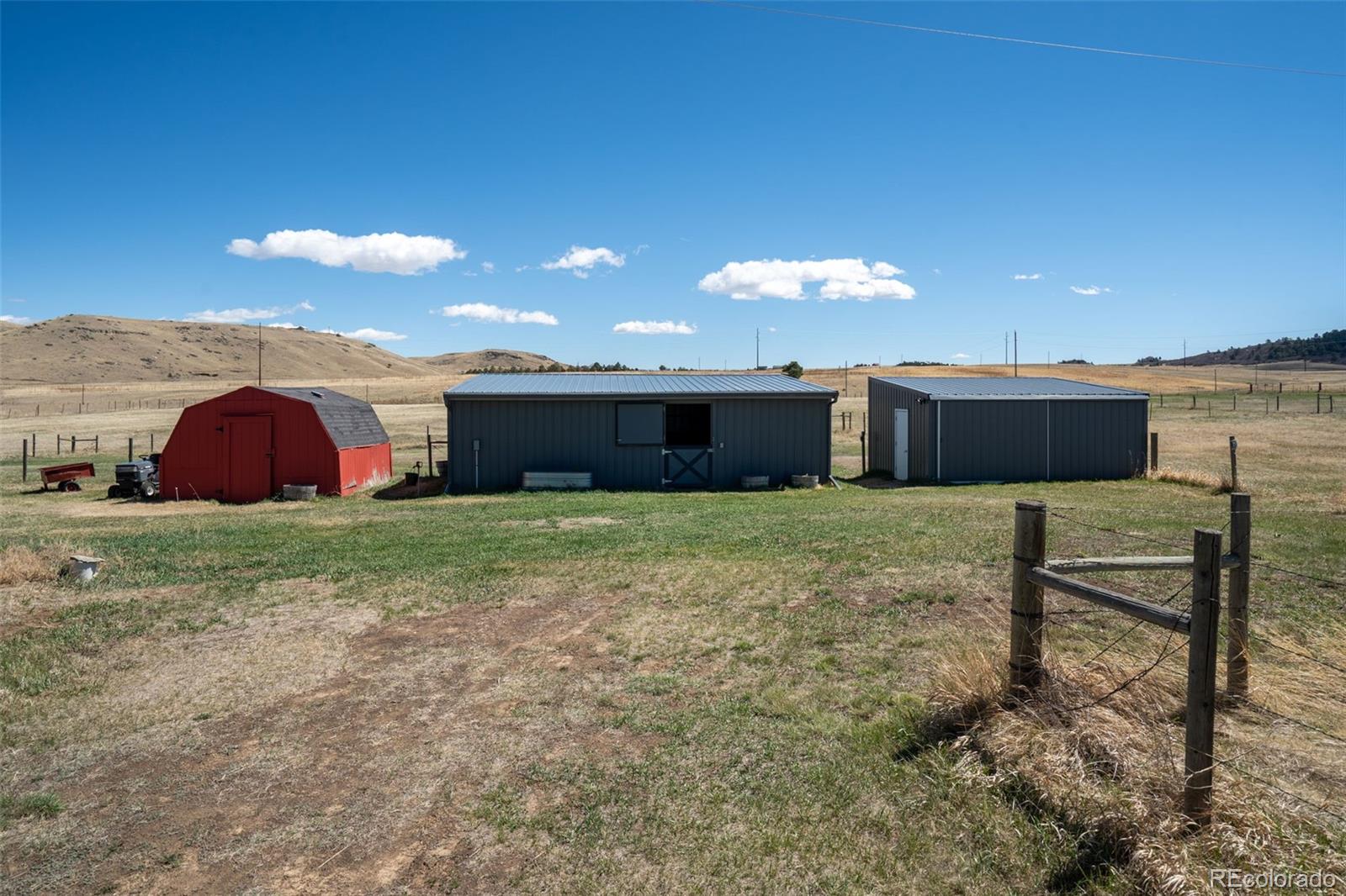 12360 South Mesa View Road Larkspur, CO 80118 - Photo 44 of 50 a front view of a house with a yard