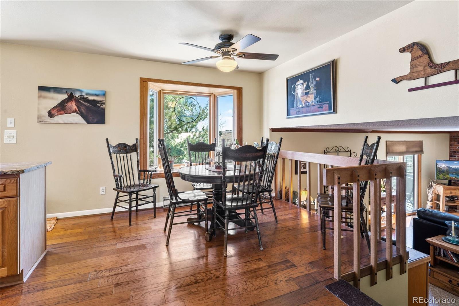 12360 South Mesa View Road Larkspur, CO 80118 - Photo 5 of 50 a view of a a dining room with furniture window and wooden floor