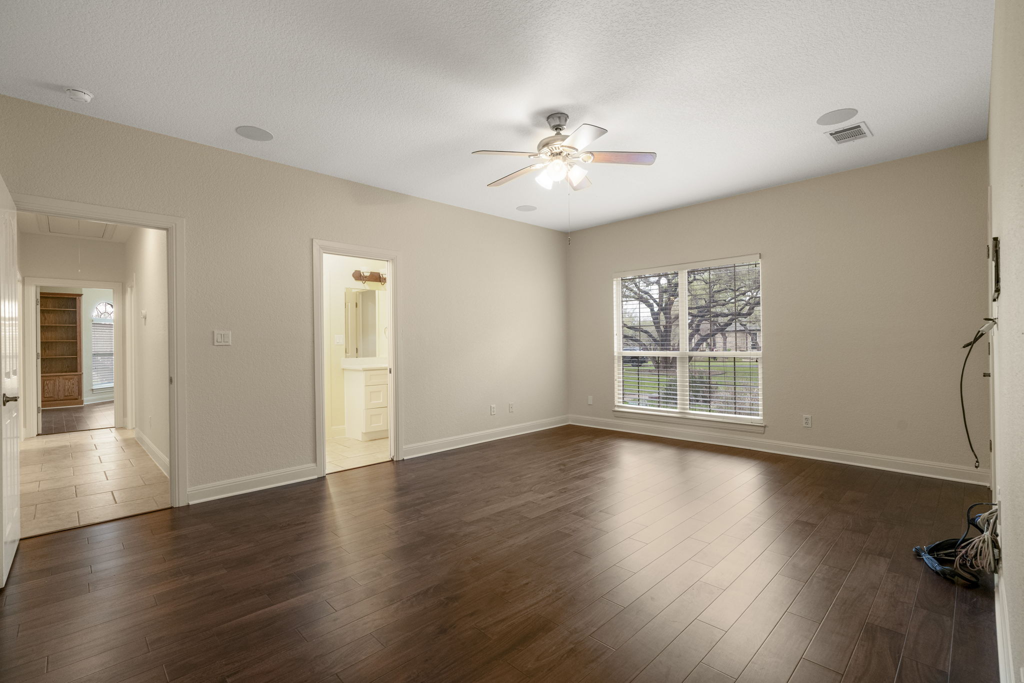 301 Goldridge Drive Georgetown, TX 78633 - Photo 23 of 40 a view of an empty room with wooden floor and a window