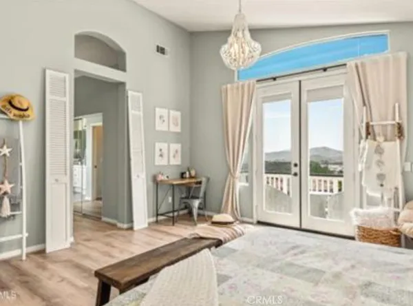 a living room with furniture a dining table and a large window