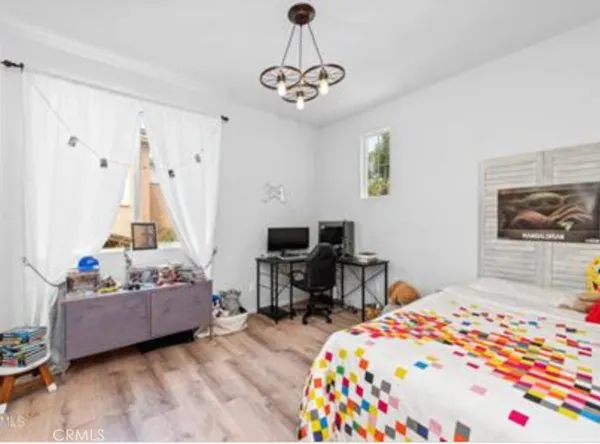 a bedroom with bed and window