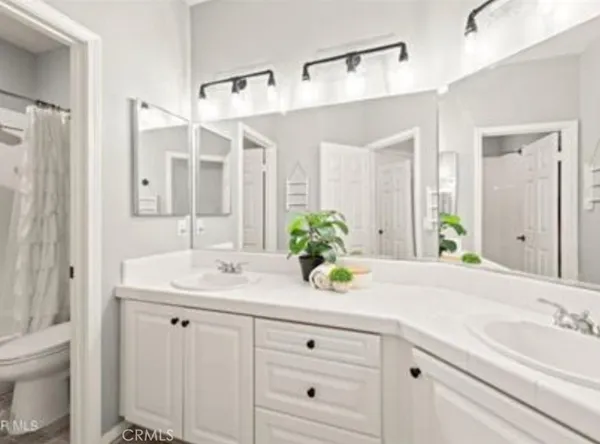 a bathroom with a sink double vanity granite and a mirror