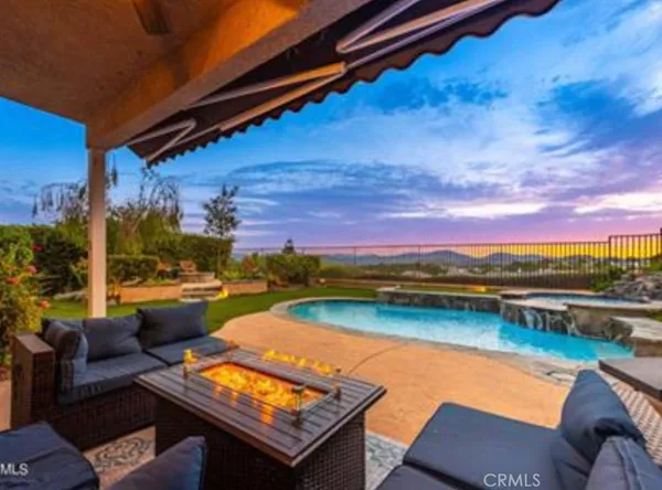 a view of swimming pool with outdoor seating