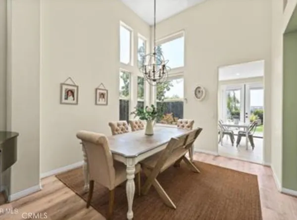 a view of a dining room with furniture and chandelier