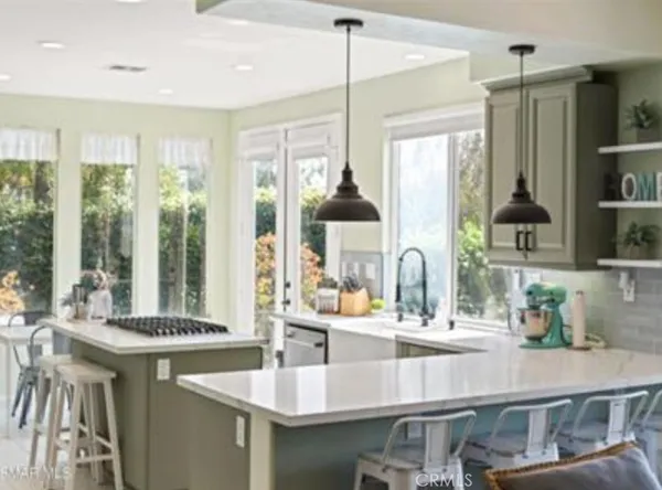 a kitchen with stainless steel appliances granite countertop a sink and a counter space