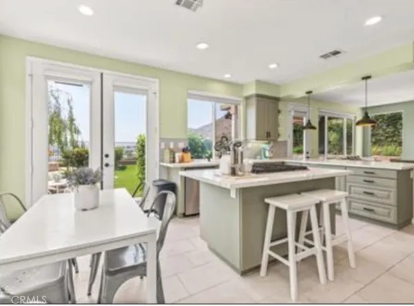 a kitchen with a table chairs sink and cabinets