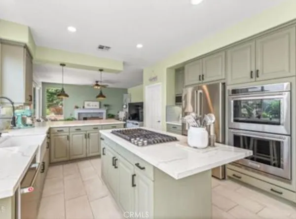 a kitchen with a stove a refrigerator and a sink