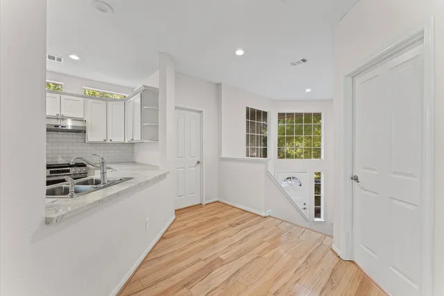 a kitchen with a stove a sink and a refrigerator
